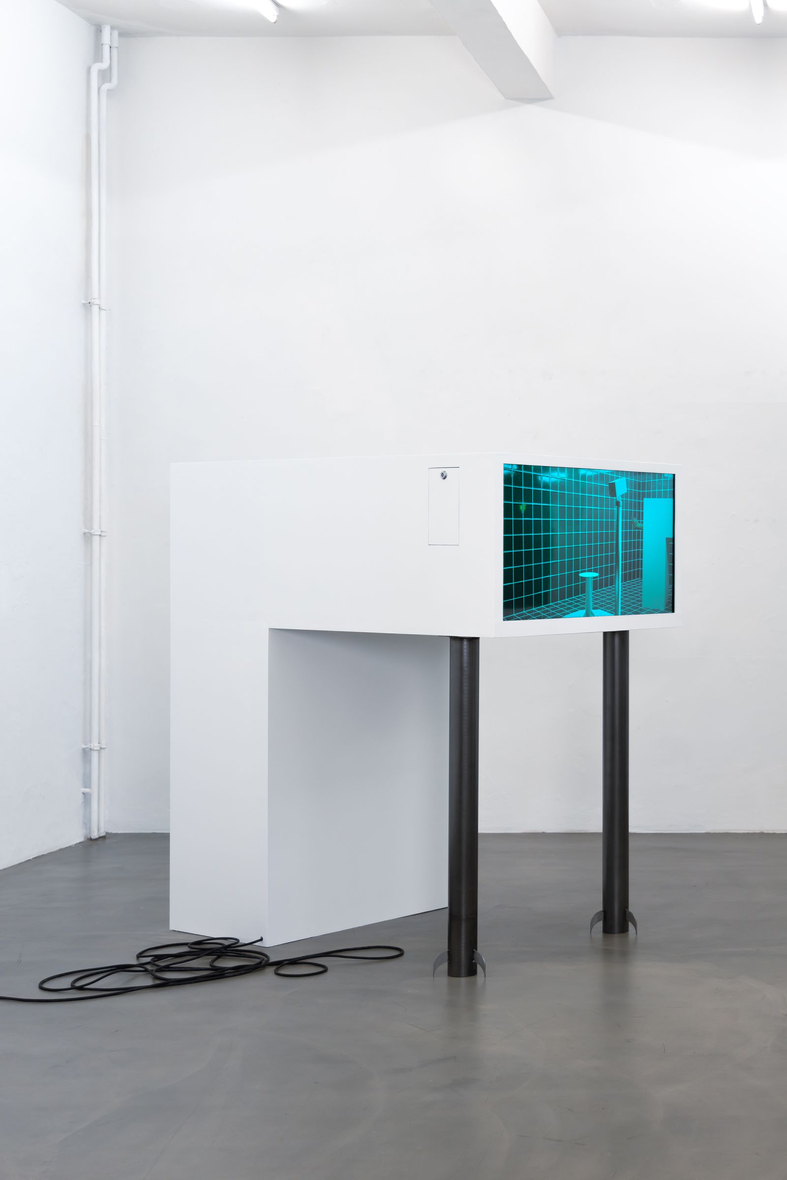 a white/metal sculpture with an embedded screen