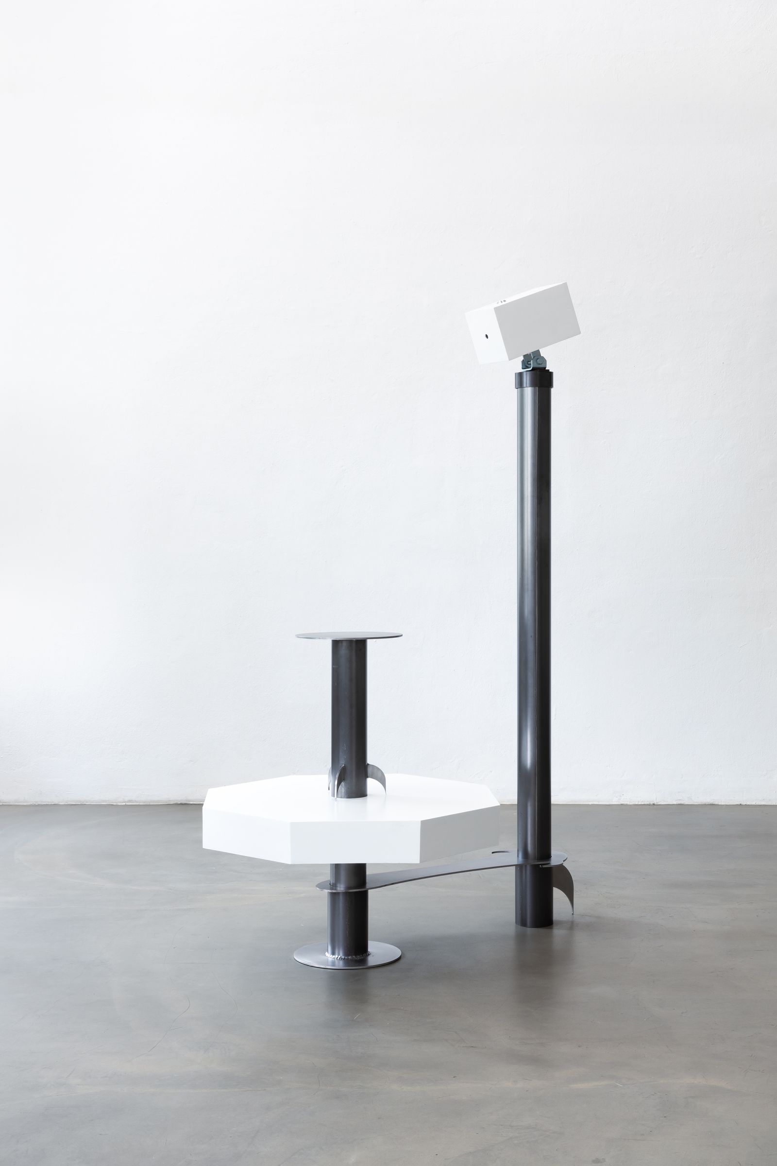 a metal sculpture that looks like a camera pointing at a seat