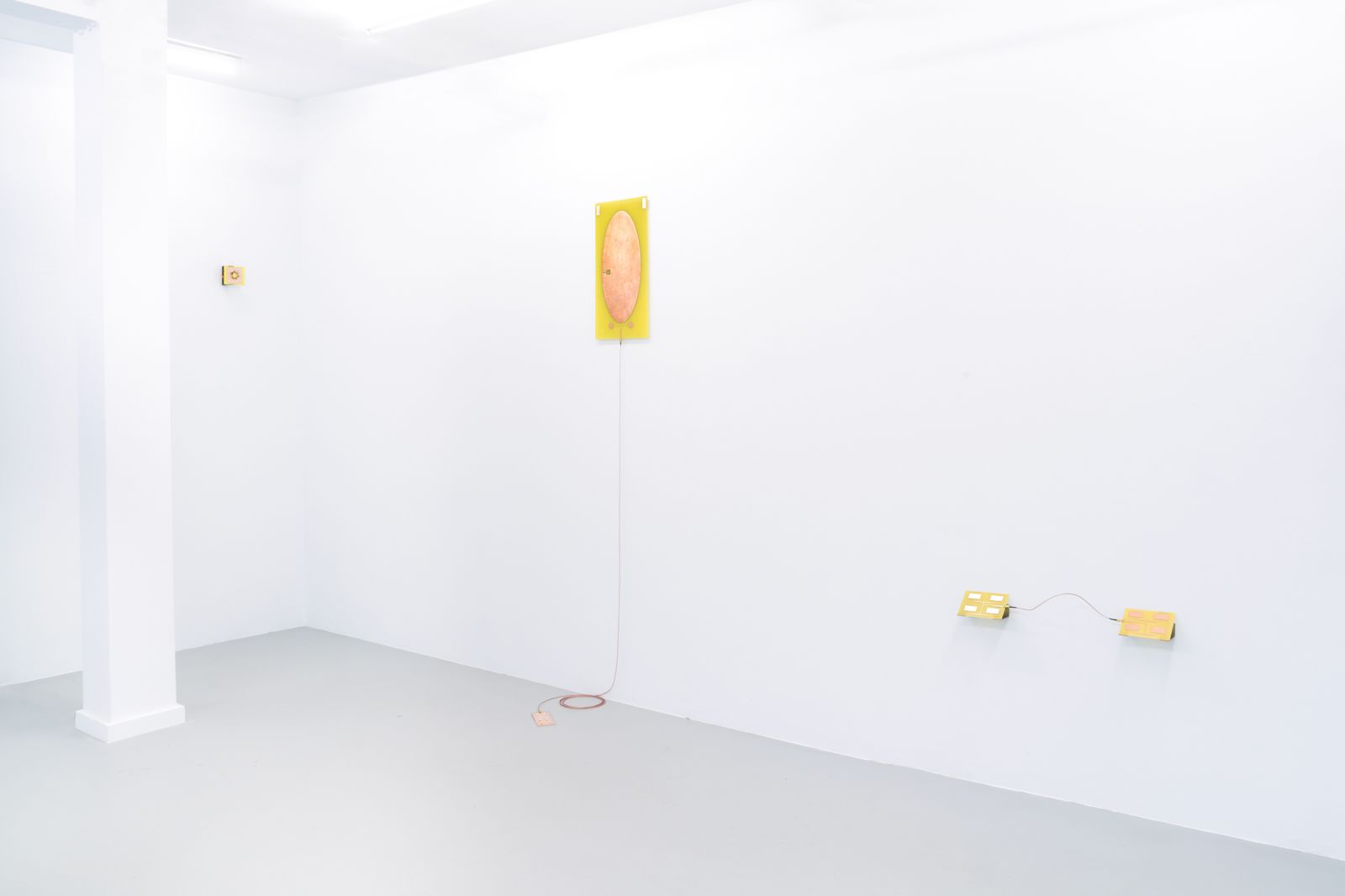 a white gallery space with 3 sculptures