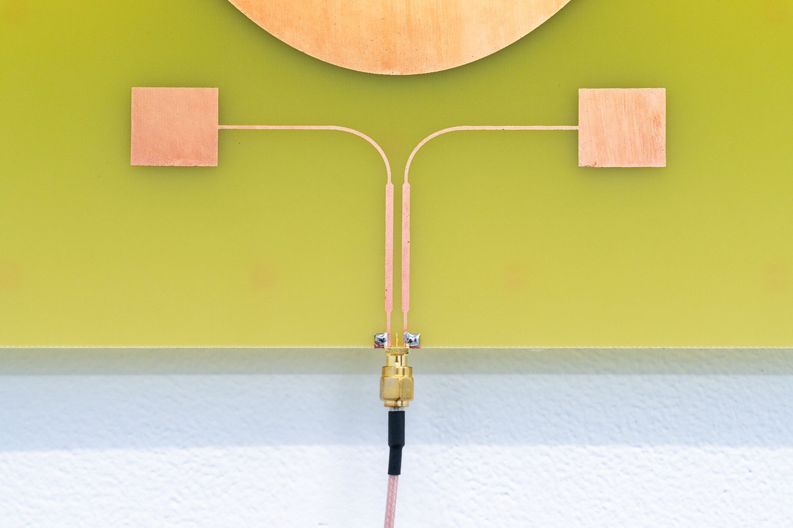 the bottom of a pcb board with a copper wire attached to it